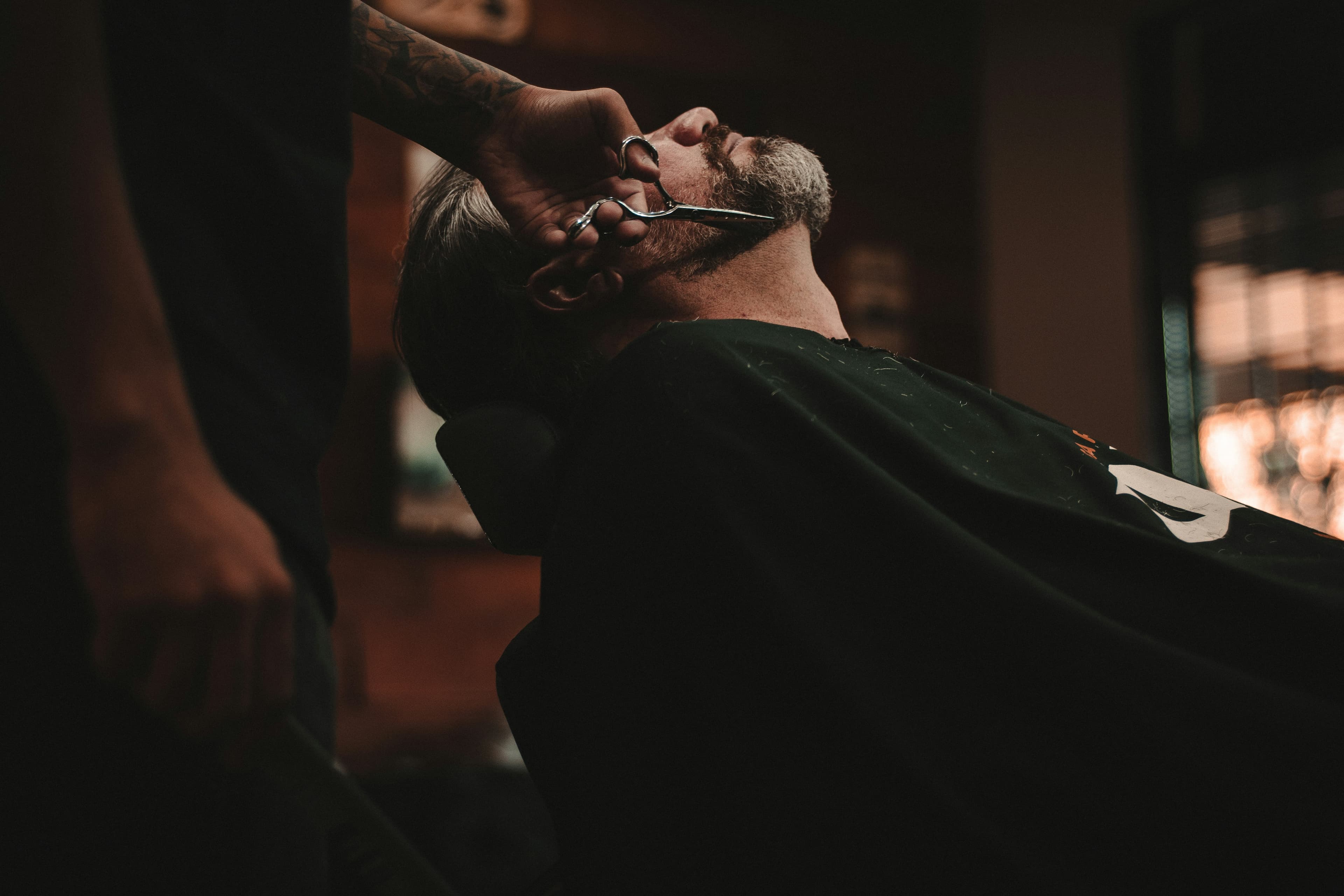 Barber shaving a client
